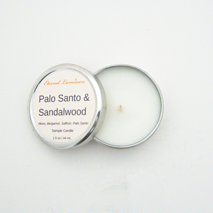 A 1.5oz Palo Santo& Sandalwood sample candle in a tin jar sitting against a white background made by Eternel Luminen.