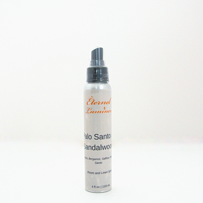 A 4oz Palo Santo & Sandalwood room & linen spray sitting against a white background made by Eternel Luminen.