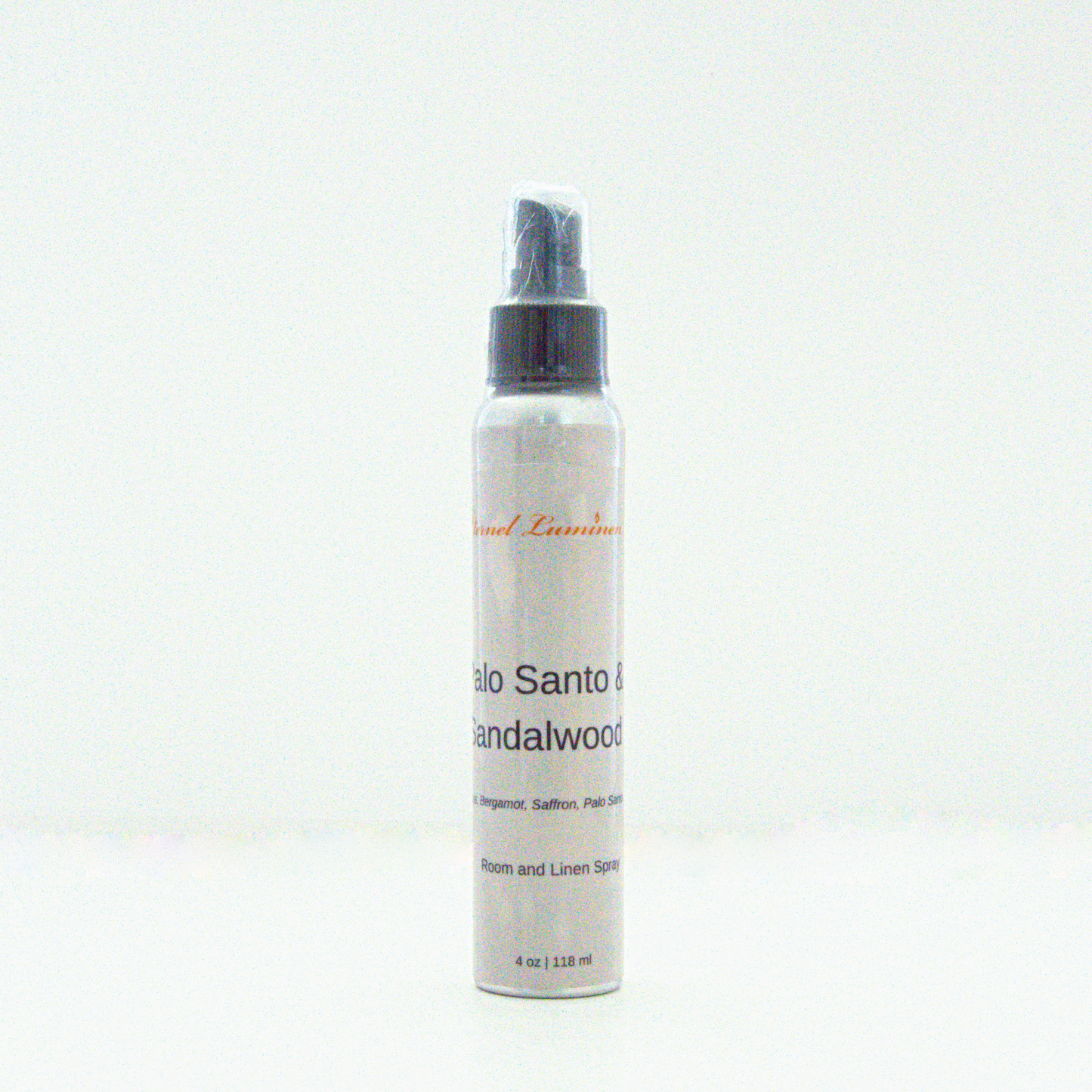 A 4 oz Palo Santo &Sandalwood room & linen spray sitting against a white background made by Eternel Luminen.