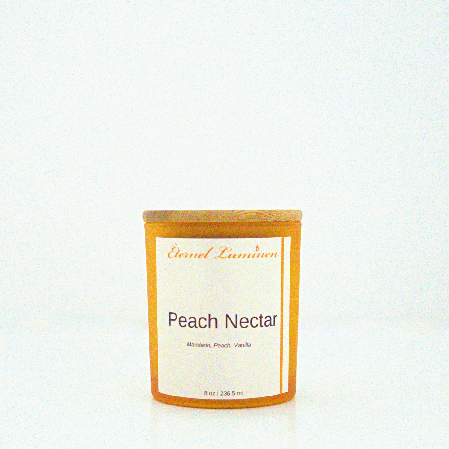 A 8 oz Peach Nectar frosted candle with a wooden lid sitting against a white background made by Eternel Luminen.