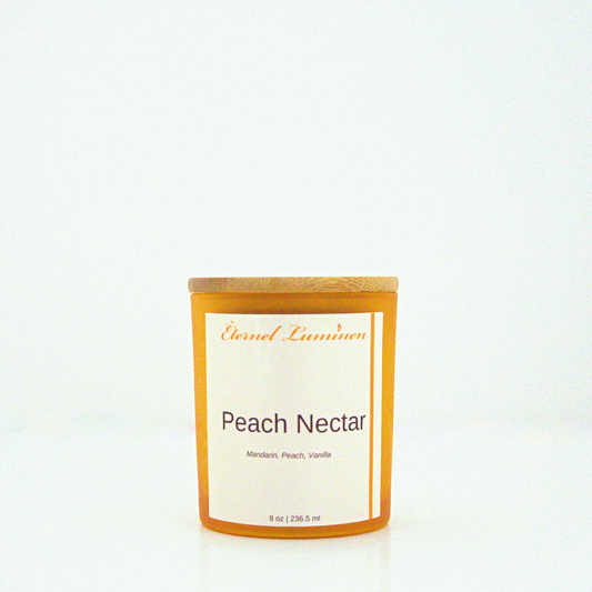 A 8 oz Peach Nectar frosted candle with a wooden lid sitting against a white background made by Eternel Luminen.