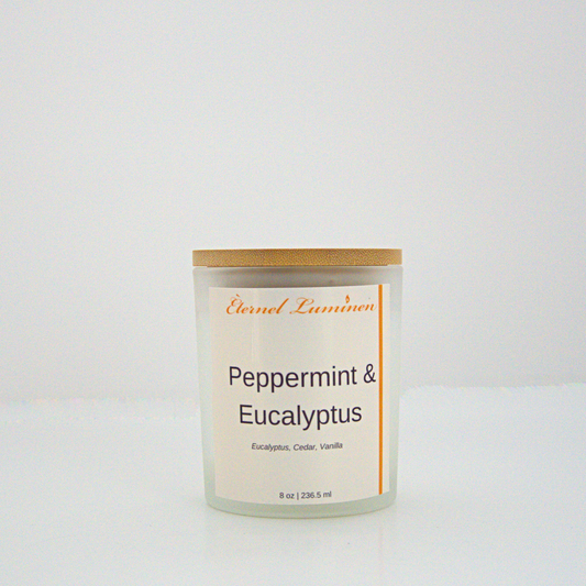 A 8 oz peppermint and eucalyptus frosted candle with a wooden lid sitting against a white background made by Eternel Luminen.