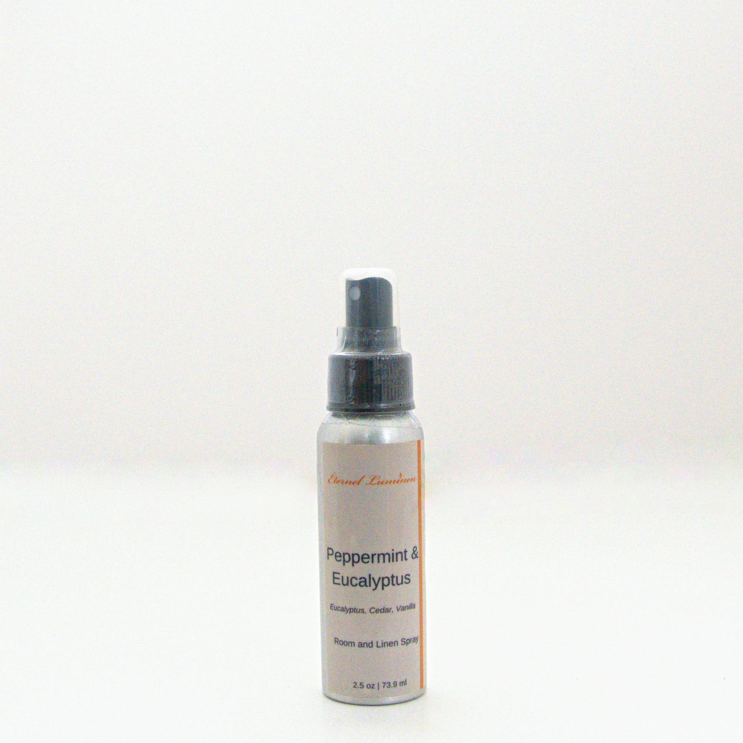 A 2.5oz Peppermint & Eucalyptus room & linen spray sitting against a white background made by Eternel Luminen. 