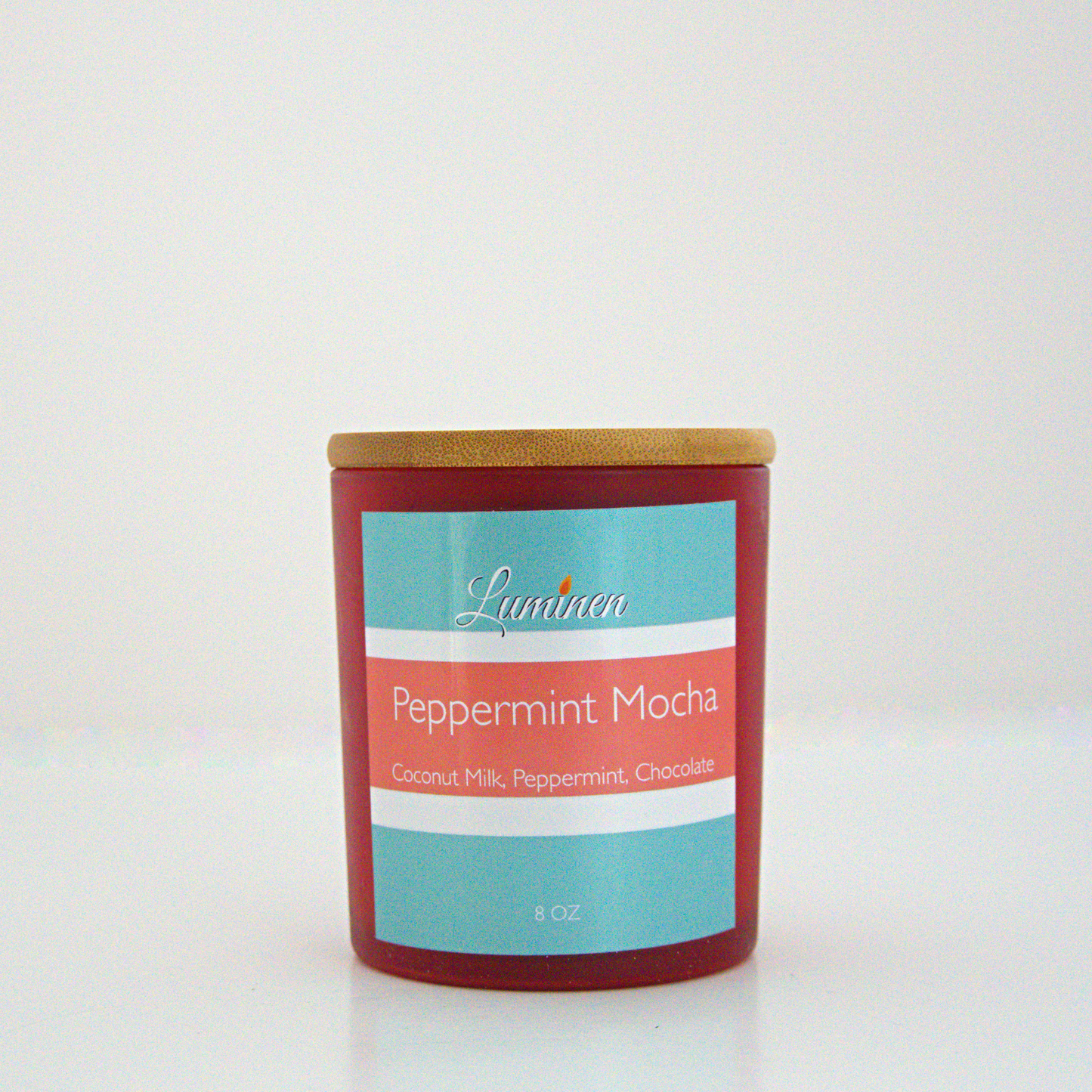 A 8oz peppermint mocha frosted candle with a wooden lid sitting against a white background made by Eternel Luminen.