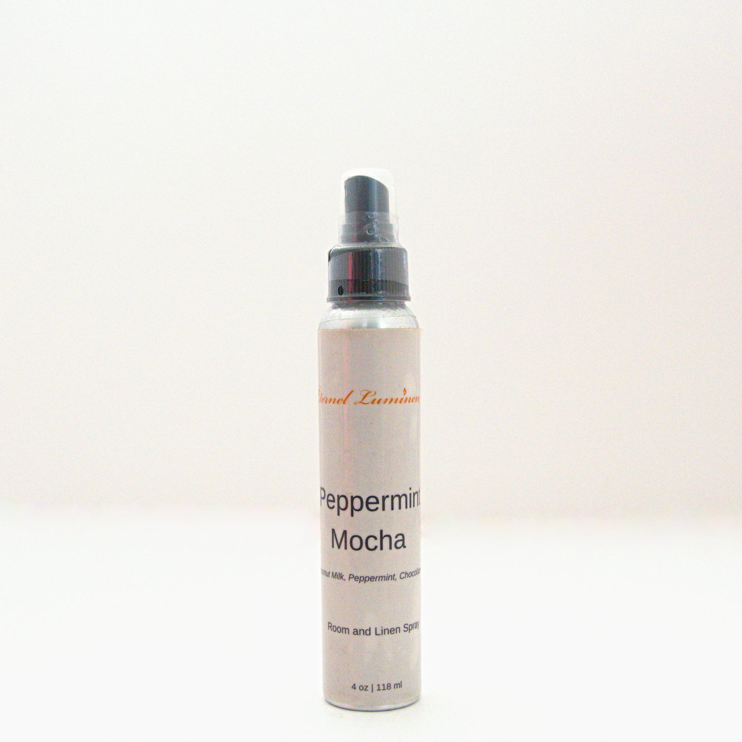 A 4oz Peppermint Mocha room & linen spray sitting against a white background made by Eternel Luminen. 