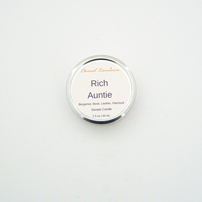 A 1.5oz Rich Auntie sample candle in a tin jar sitting against a white background made by Eternel Luminen