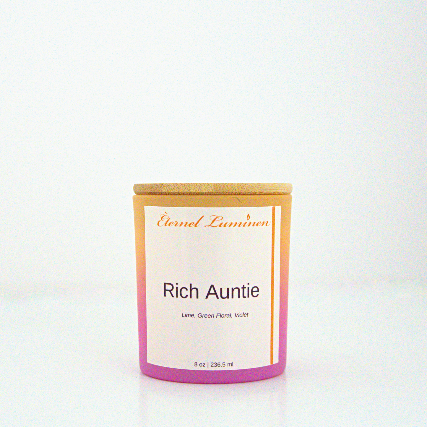 A 8 oz frosted Rich Auntie candle with a wooden lid sitting against a white background made by Eternel Luminen.