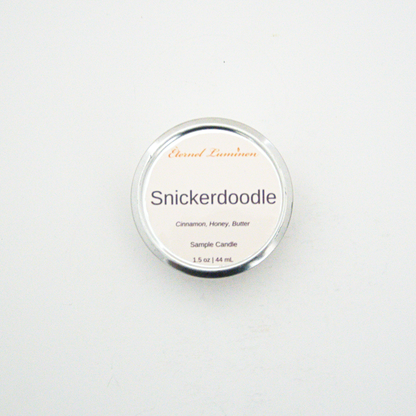 A 1.5oz Snickerdoodle sample candle in a tin jar sitting against a white background made by Eternel Luminen