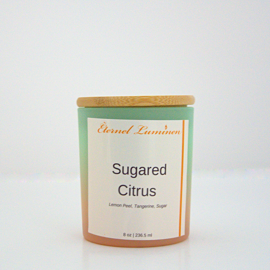 A 8 oz Sugared citrus frosted candle with a wooden lid sitting against a white background made by Eternel Luminen.