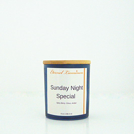 A 8oz Sunday Night Special frosted candle with a wooden lid sitting against a white background made by Eternel Luminen.