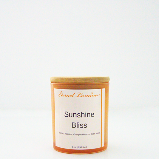 A 8 oz frosted Sunshine Bliss candle with a wooden lid sitting against a white background made by Eternel Luminen.