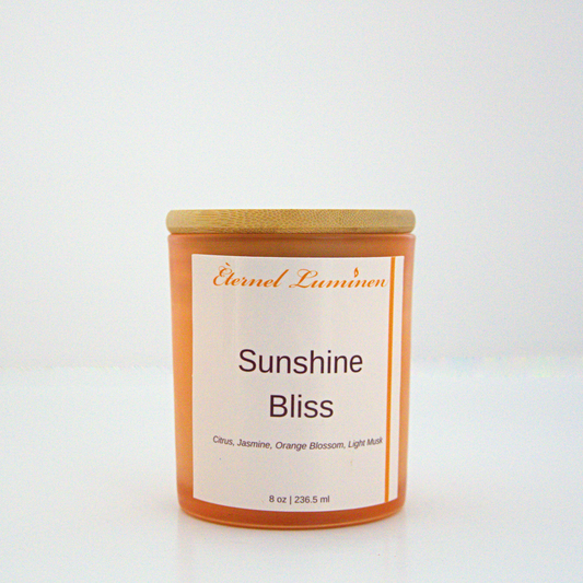 A 8 oz frosted Sunshine Bliss candle with a wooden lid sitting against a white background made by Eternel Luminen.