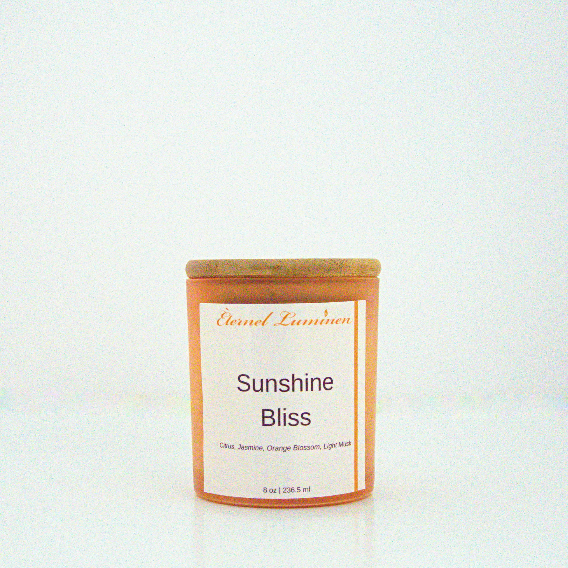 A 8 oz frosted Sunshine Bliss candle with a wooden lid sitting against a white background made by Eternel Luminen.