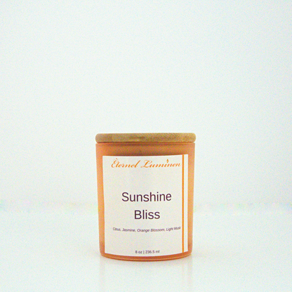 A 8 oz frosted Sunshine Bliss candle with a wooden lid sitting against a white background made by Eternel Luminen.