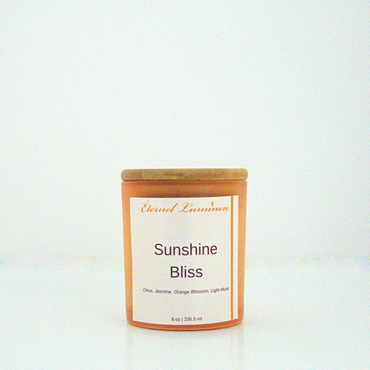 A 8 oz frosted Sunshine Bliss candle with a wooden lid sitting against a white background made by Eternel Luminen.