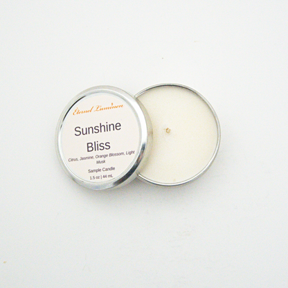 A 1.5oz Sunshine Bliss sample candle in a tin jar with the lid off sitting against a white background made by Eternel Luminen.