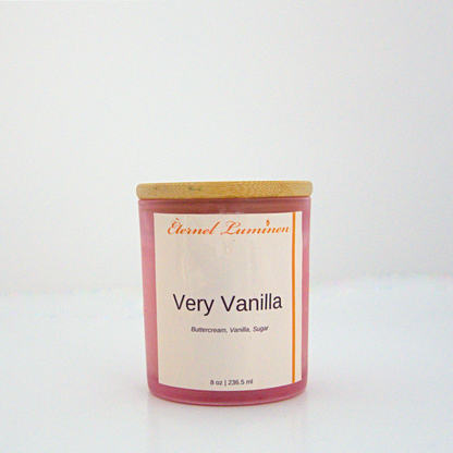 A 8 oz frosted Very Vanilla candle with a wooden lid sitting against a white background made by Eternel Luminen.