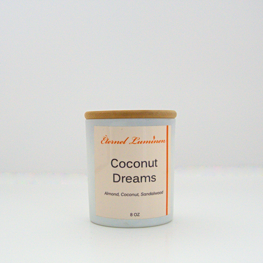 A 8 oz frosted Coconut Dreams candle with a wooden lid sitting against a white background made by Eternel Luminen.