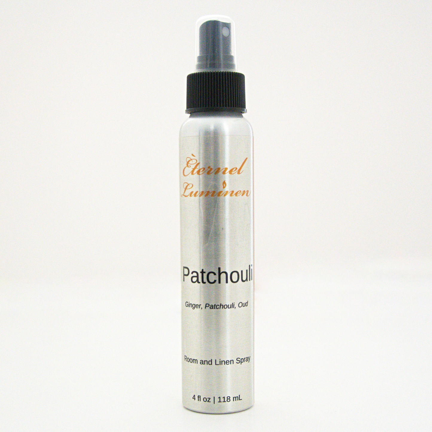 A 4oz Patchouli room & linen spray sitting against a white background made by Eternel Luminen. 